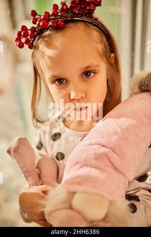 Cute girl holding stuffed toys at home Stock Photo