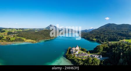 Austria, Salzburg, Hof bei Salzburg, Drone panorama of Lake Fuschl and Schloss Fuschl in summer Stock Photo