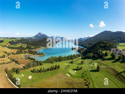 Austria, Salzburg, Hof bei Salzburg, Drone view of Lake Fuschl and surrounding golf course in summer Stock Photo