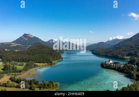 Austria, Salzburg, Hof bei Salzburg, Drone view of Lake Fuschl in summer with Schloss Fuschl in background Stock Photo