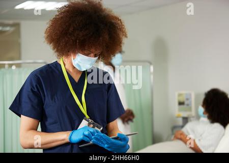 Female nurse using tablet PC in medical room Stock Photo