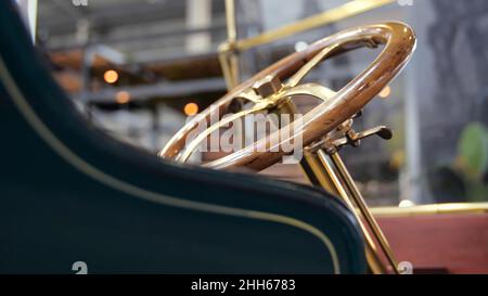 Basket in delivery retro car. Media. Vintage delivery service on European retro cars. Close-up of wicker basket behind car with retro body and steerin Stock Photo