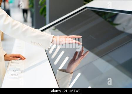 Businesswoman using touch screen device at office Stock Photo