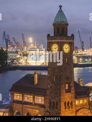 Germany, Hamburg, Saint Pauli Piers clock tower with docked cruise ship in background Stock Photo