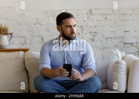 Serious business man using online app on mobile phone Stock Photo
