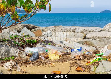 KOTA KINABALU, SABAH, MALAYSIA - JANUARY 06, 2022: Garbage and plastic bottles on a beach left in Tanjung Aru Beach Stock Photo