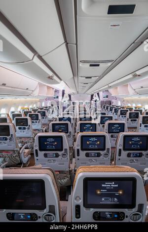 Singapore - January 2022: Singapore Airlines aircraft interior with economy class passenger seats at Singapore Changi Airport. Stock Photo