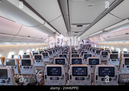 Singapore - January 2022: Singapore Airlines aircraft interior with economy class passenger seats at Singapore Changi Airport. Stock Photo