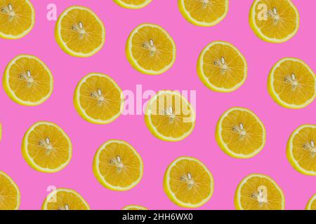 Half lemon slices, top view of lemon slices isolated on pink background. Citrus fruit pattern concept photo. Stock Photo