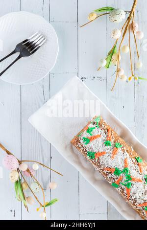 Top down view of a carrot cake jelly roll with plates ready for serving. Stock Photo