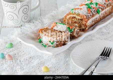 A platter of carrot cake jelly roll sliced into with plates for serving. Stock Photo