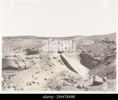 Assouan (Syène), Carrières de Granit - Ancien Système d'Extraction 1851–52, printed 1853–54 Félix Teynard French Most of the colossi and obelisks of ancient Egypt were cut from this granite quarry in Nubia. The clean diagonal mass in the center is an unfinished obelisk, evidently abandoned when a crack traveled down its 100-foot length. For Teynard, a civil engineer intent on describing the sites and monuments along the Nile, it served as a pointer sighting a distant temple just visible on the horizon.. Assouan (Syène), Carrières de Granit - Ancien Système d'Extraction  261884 Stock Photo