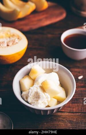 Ice Cream with Honeydew Melon Slices in Bowl Stock Photo