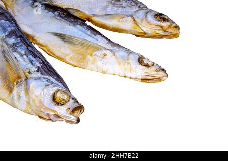 Three dried fish Osmeridae isolated on white background Stock Photo