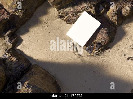 Blank book model placed on rocks in the sand, notebook mockup, mockup on nature background 01 Stock Photo