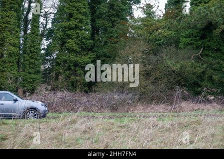 Silver Nissan Juke Mark One motor car driving on a country lane across Salisbury Plain Stock Photo