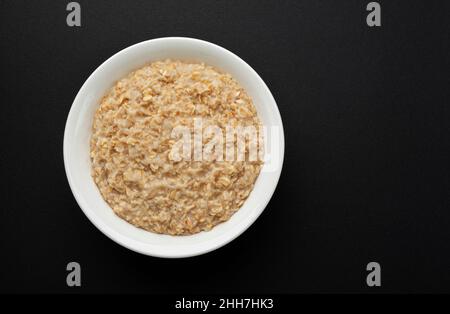 Bowl of oatmeal on black background  Stock Photo