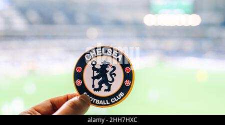 September 12, 2021, London, United Kingdom. The emblem of the Chelsea F.C. football club on the background of a modern stadium. Stock Photo