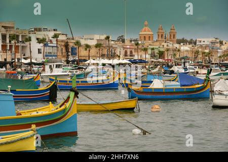 Typical fishing boats at the village of Marsaxlokk on the island of Malta Stock Photo