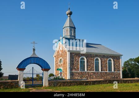 Old ancient orthodox stone church of the Intercession of the Blessed Virgin Mary at summer. Benitsa, Belarus. Stock Photo