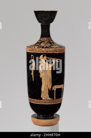 Terracotta lekythos (oil flask) ca. 480 B.C. Attributed to the Brygos Painter Girl playing aulos (double flute)Although this depiction may be considered an excerpt from a symposium scene (drinking party), it is perfectly satisfactory in itself—partly because it is so masterfully composed. Behind the musician hangs a flute case with the receptacle for the mouthpiece.. Terracotta lekythos (oil flask). Greek, Attic. ca. 480 B.C.. Terracotta; red-figure. Classical. Vases Stock Photo