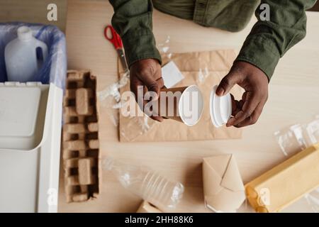 Top view close up of African-American man preparing household waste for recycling, copy space Stock Photo