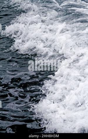 Boat Wave ocean trace on blue sea fresh water background. Deep ocean water surface trail bubble foaming Stock Photo