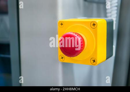 Machine control panel with red switch button - emergency stop at factory Stock Photo