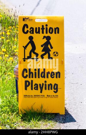 Yellow Caution Children Playing warning sign. Stock Photo