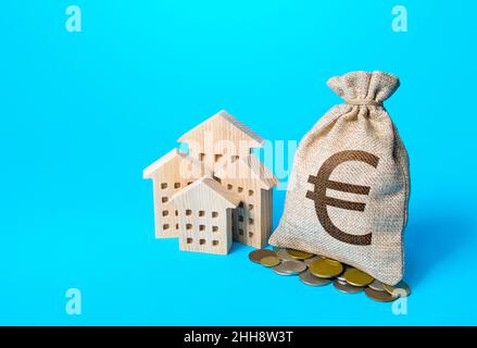 Houses and euro money bag. Increasing property value. Fair market price. Home taxation. Residential or commercial property income. Municipal budget. R Stock Photo