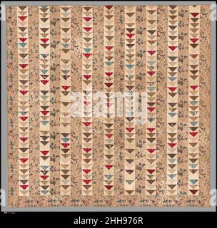 Quilt, Flying Geese pattern ca. 1840–50 American The top has pieced rows alternating with bands of chintz. The pieced rows are quilted in chevrons, while the chintz rows are diamond quilted. The border is quilted with diagonal parallel lines. The Flying Geese triangles are cut from a variety of small cotton prints, primarily in shades of browns and reds. The light brown chintz used for the bands and border is printed with rose vines. The quilt has a plain white woven cotton backing and a tape binding striped in white, brown, blue, and green.. Quilt, Flying Geese pattern  13881 Stock Photo