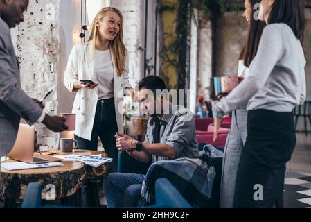 Group of students sitting together and studying. Stock Photo