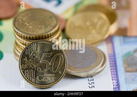 Close-up of euro coins on euro bills of different values  Stock Photo