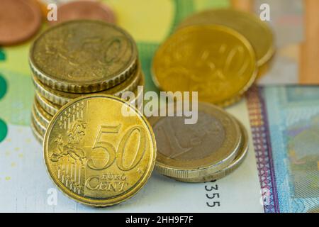 Close-up of euro coins on euro bills of different values  Stock Photo
