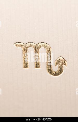 Close up horoscope sign of the zodiac symbol in gold leaf representing the constellation of Scorpio Stock Photo