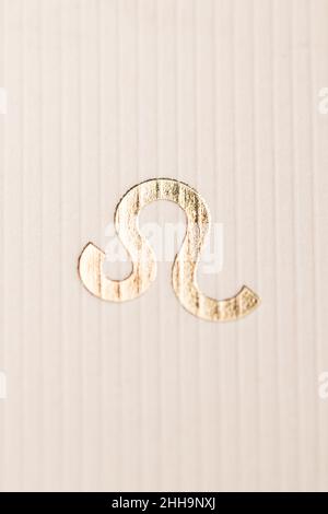 Close up horoscope sign of the zodiac symbol in gold leaf representing the constellation of Leo Stock Photo