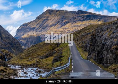 A scenic empty straight uphill road leading to Saksun, in Faroe Islands. Stock Photo