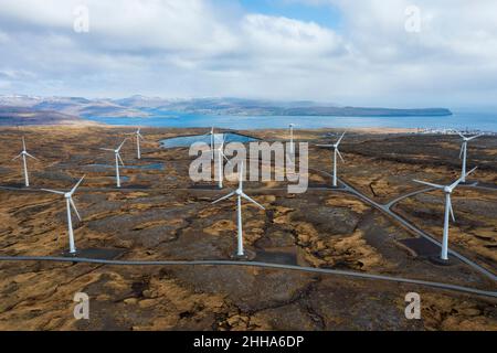 The wind turbines are not a blot on this rugged, mustard coloured landscape as they harness the fierce Faroe Island winds. Stock Photo