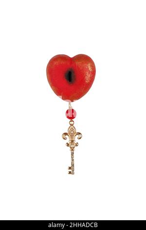 Souvenir red painted wooden heart with key isolated on white background. Stock Photo