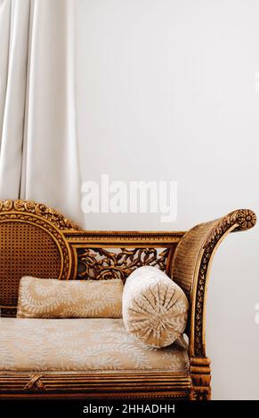 Antique arabic egyptian interior with gilded sofa and round tube pillow, heritage vintage furniture Stock Photo