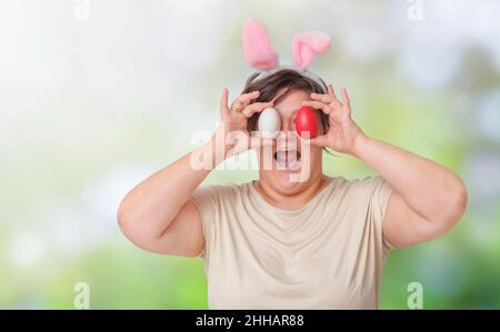 Plus size woman with easter eggs in nature Stock Photo