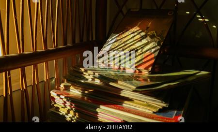 Pile of books in the library exposed to the sun Stock Photo