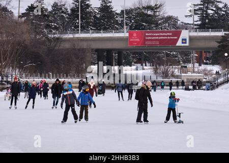 Ottawa, Ontario, Canada - January 22, 2022: Ice skaters enjoy the Rideau Canal Skateway, the 'World's Largest Skating Rink'. Stock Photo