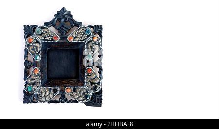 Antique black carved wood photo frame with colored pebbles Stock Photo
