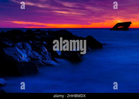 Sunset over SS Atlantus Shipwreck and Ferry in Background, Cape May, New Jersey Stock Photo