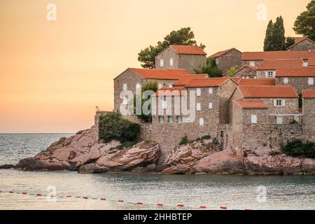 Historic buildings of the Sveti Stefan island close-up at dawn in Montenegro Stock Photo