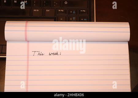 'This week', text written on notebook. Time management concept. To-do list idea. Stock Photo