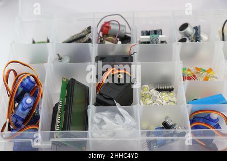 Collection of microcontroller parts in a box, Micro servo, LCD display and other electronic components for building stem projects for students Stock Photo