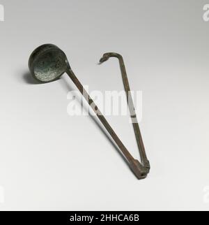 Simpulum A bronze simpulum, an ancient ceremonial ladle with a rounded bowl and ...