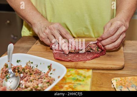 Chef wraps the minced meat in the meat to make meatloafs. French gourmet food Stock Photo